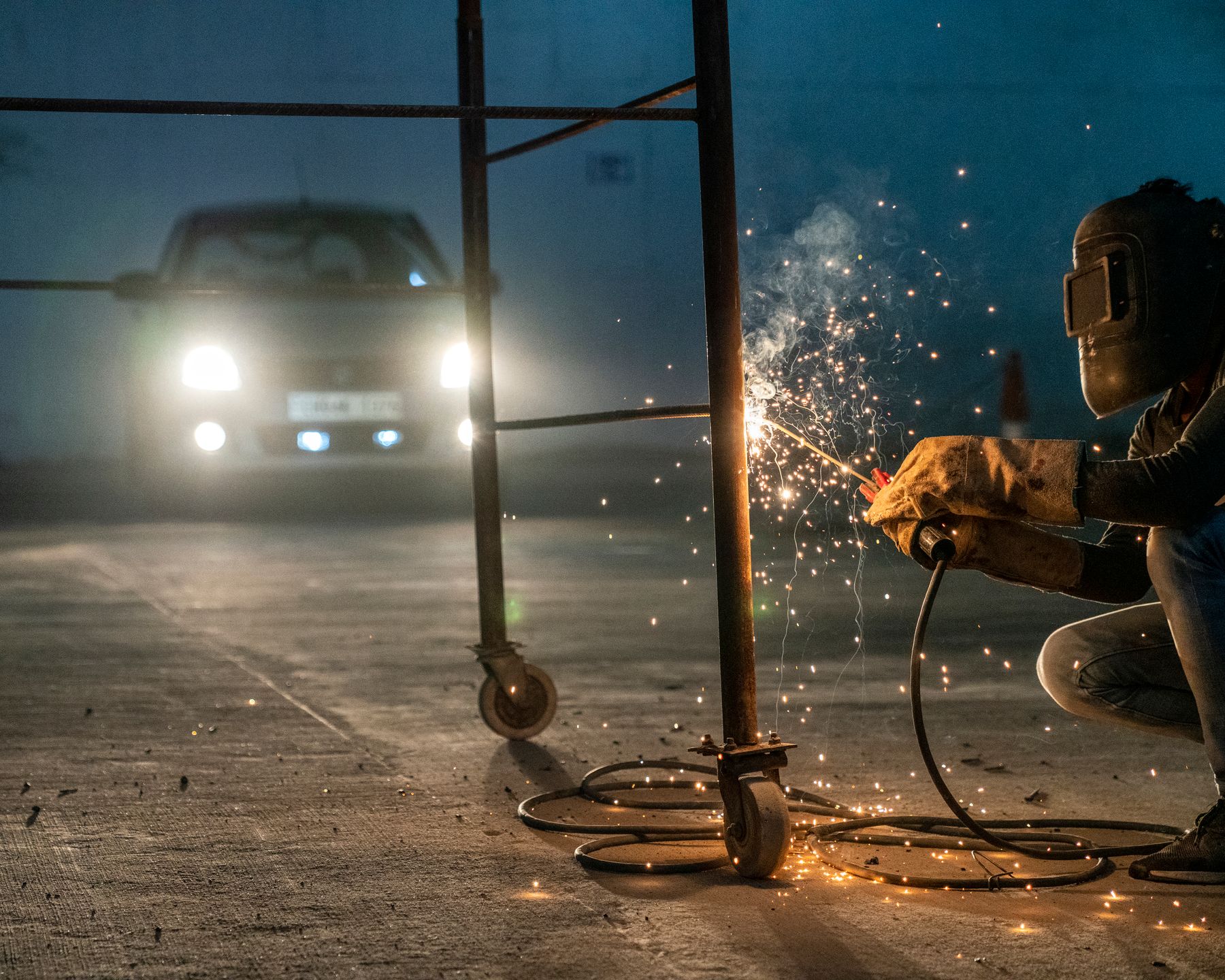 Sparks from metalwork in a garage at night